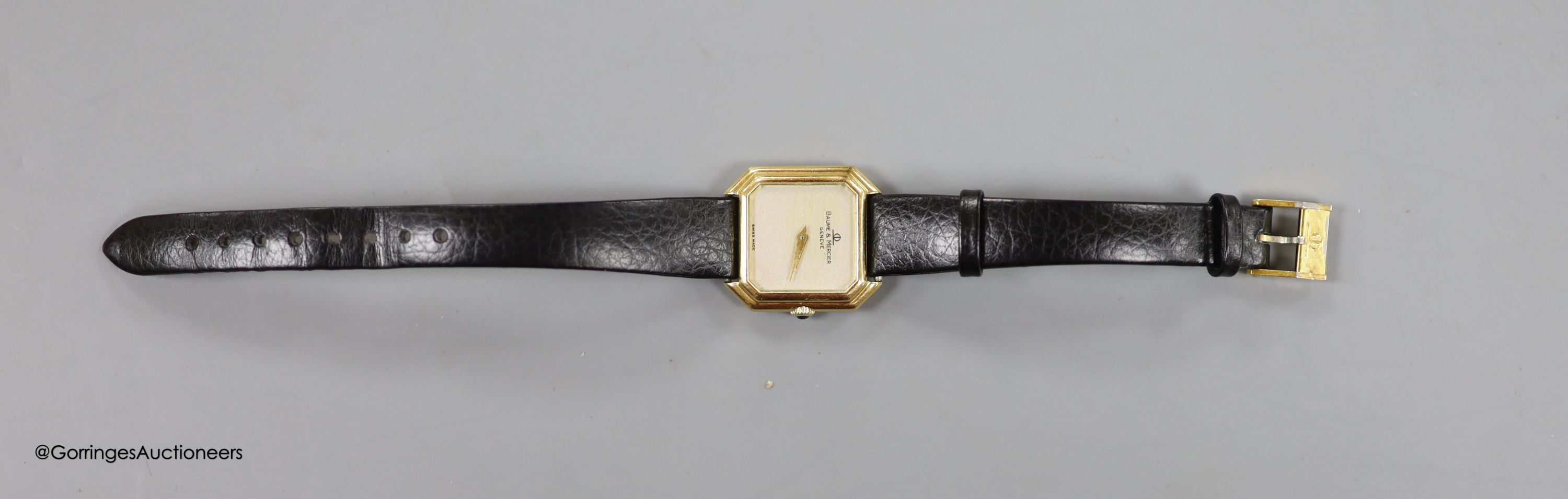 A lady's 18ct gold Baume & Mercier manual wing octagonal dial wrist watch, on associated leather strap